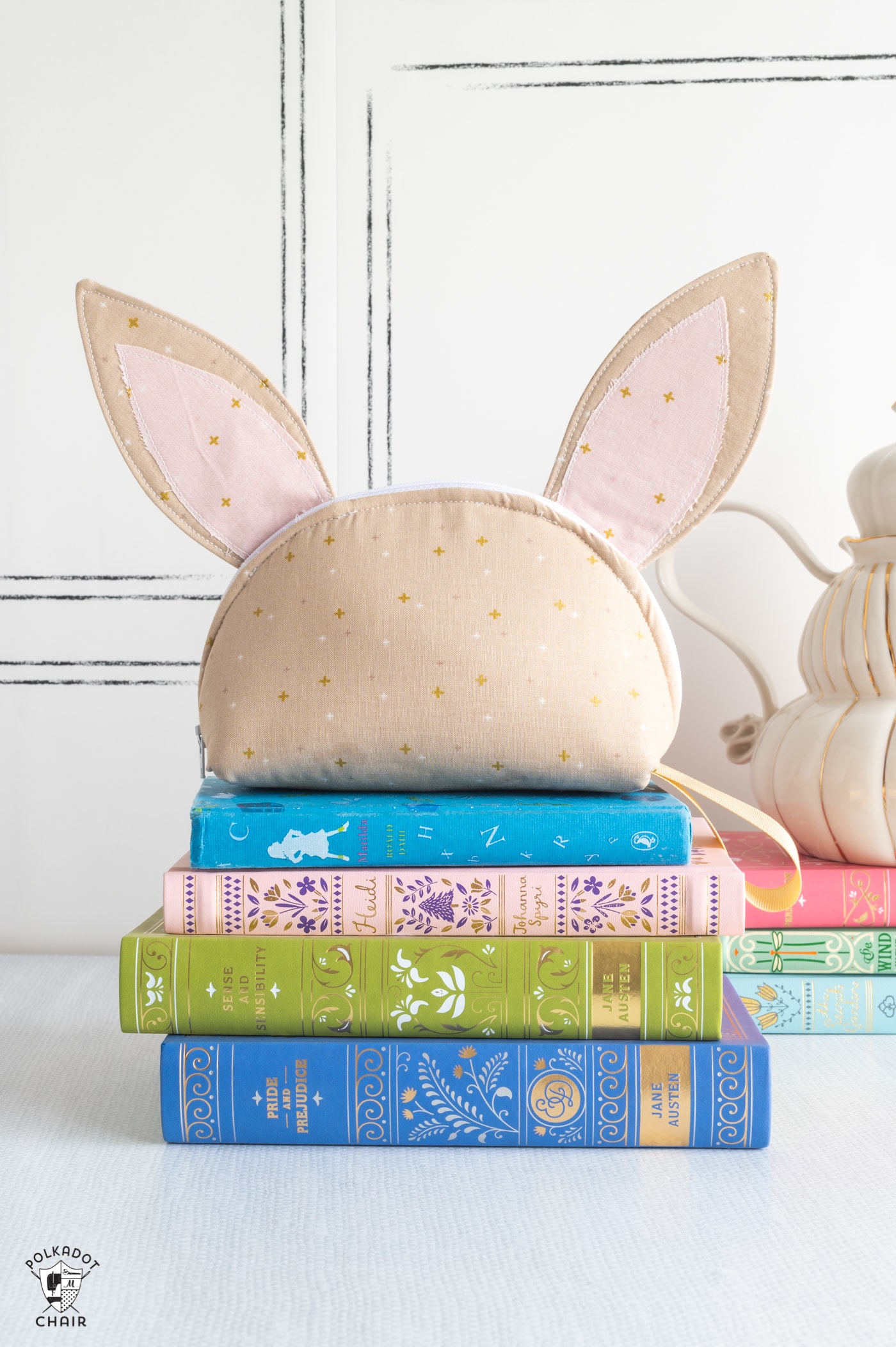 bunny zip bag on stack of books