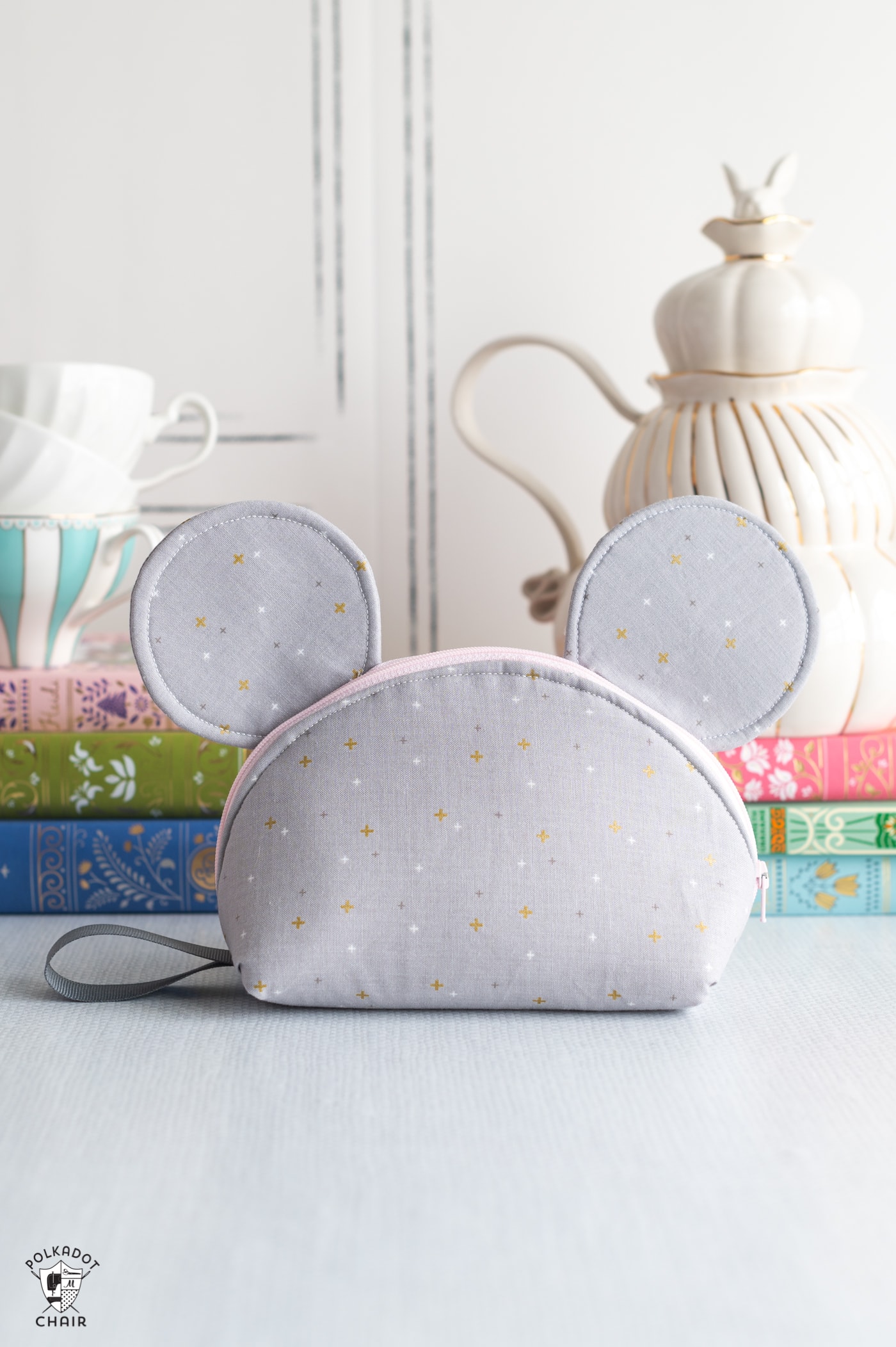 mouse zip bag with stack of books and teapot