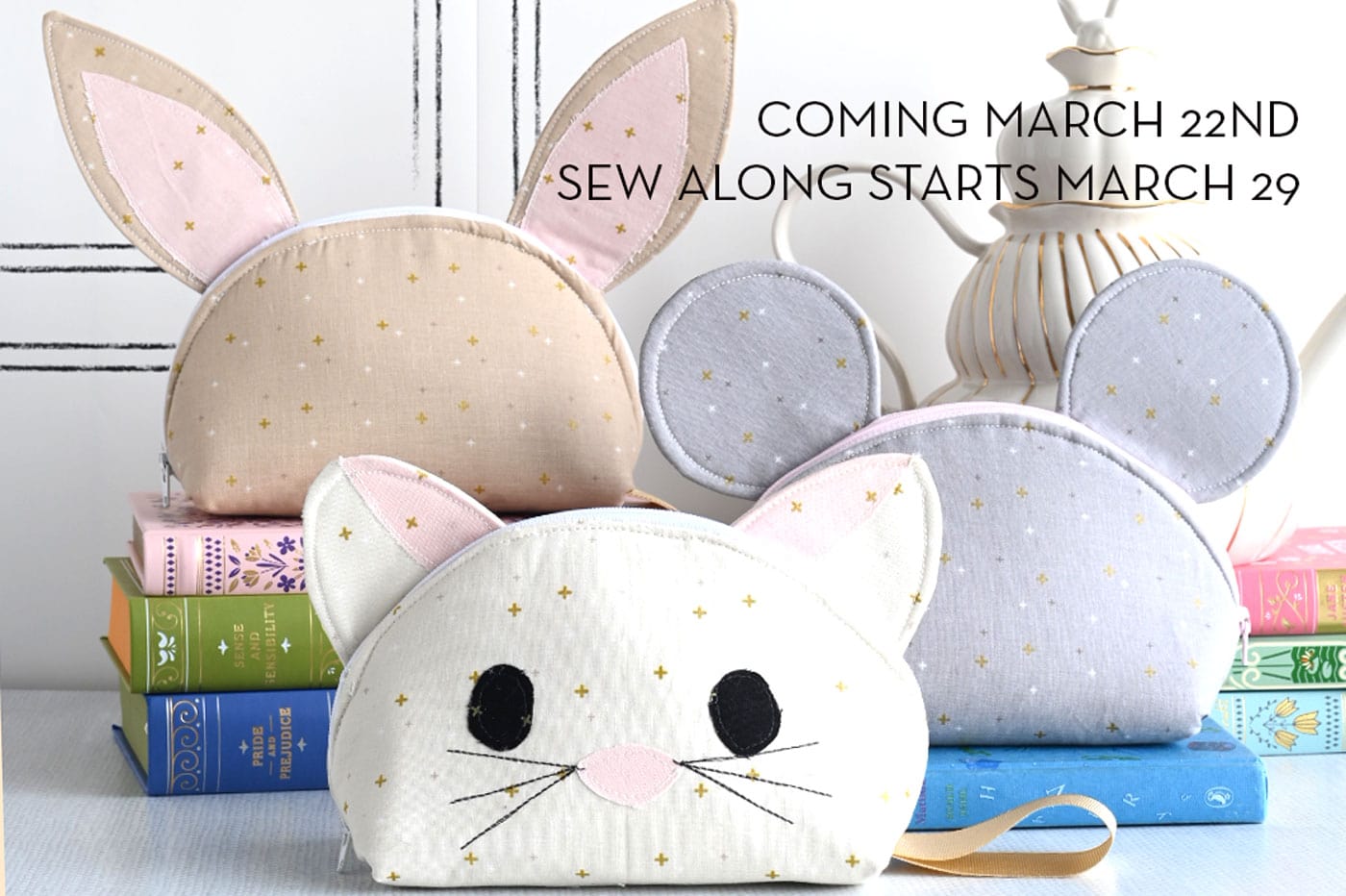 bunny, cat and mouse neutral color zip pouches on table with books