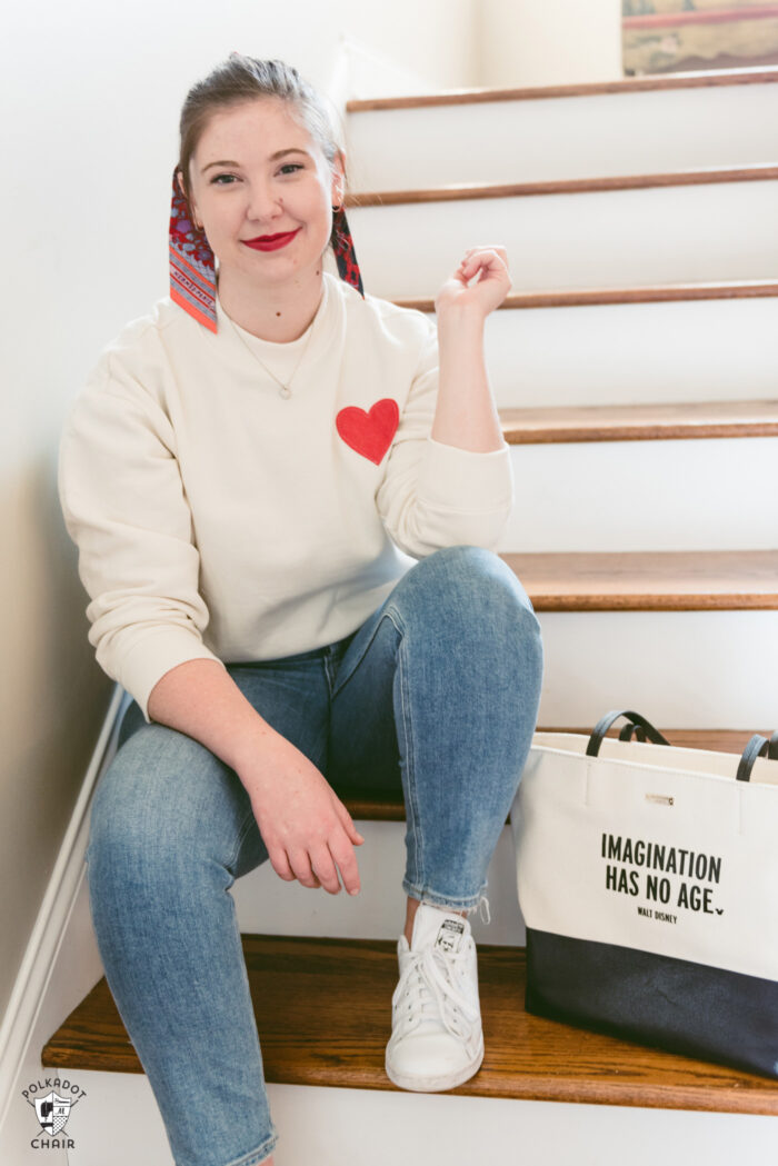 girl in ivory heart sweatshirt sitting on stairs