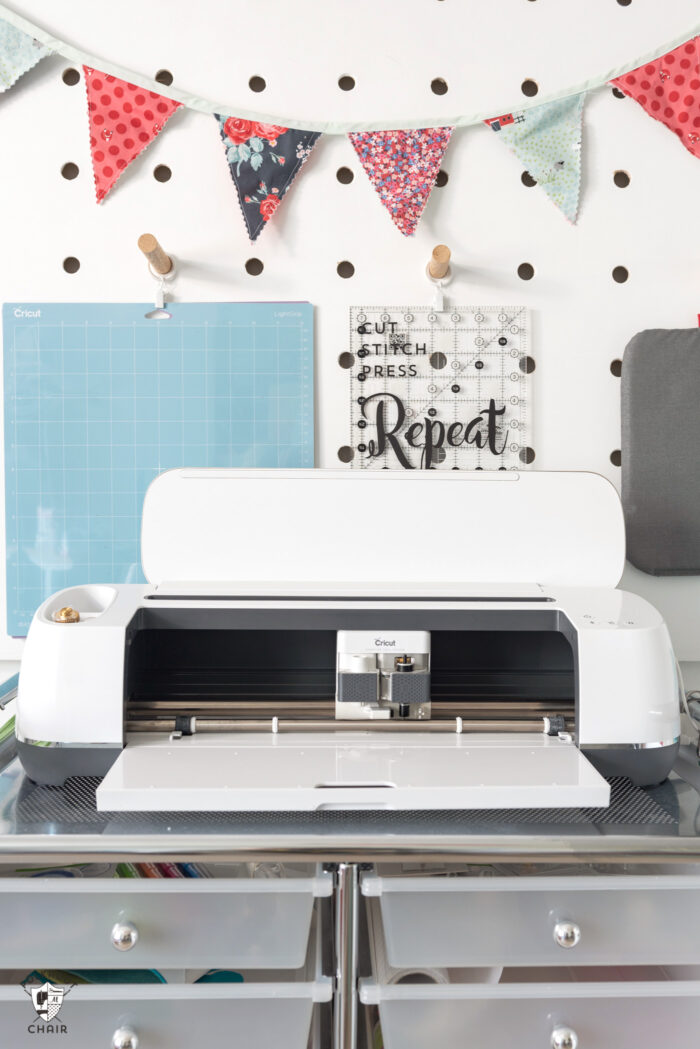 Cricut maker in front of peg wall