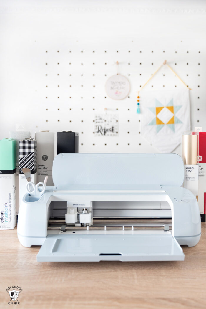 new cricut maker 3 machine on wood table in front of white wall