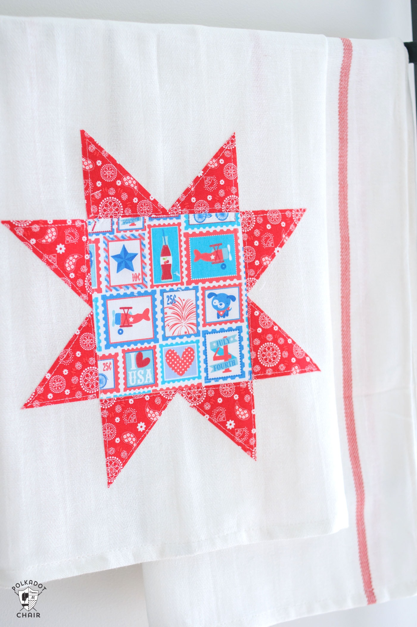 red white and blue star tea towel hanging on black rack