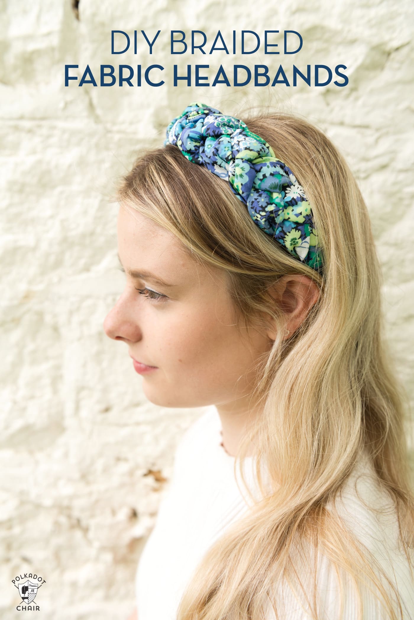 girl wearing blue braided headband in front of brick wall