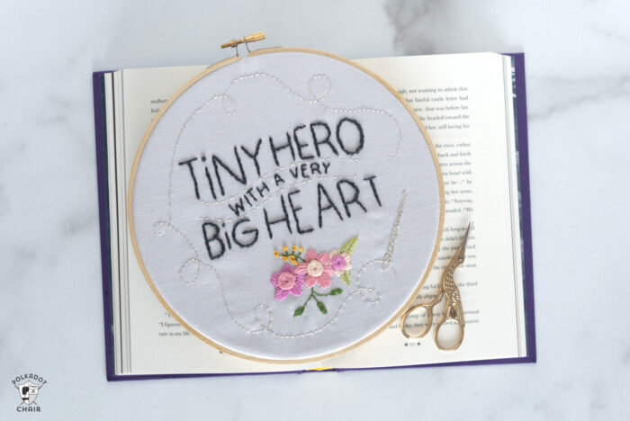 embroidery hoop on book with scissors