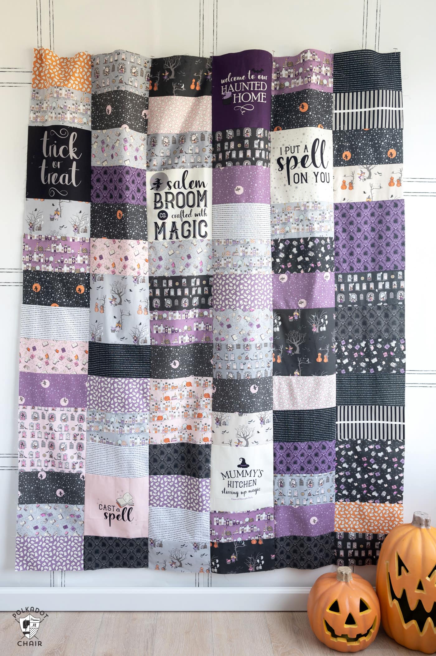 quilt made from purple, black and pink rectangles & squares.