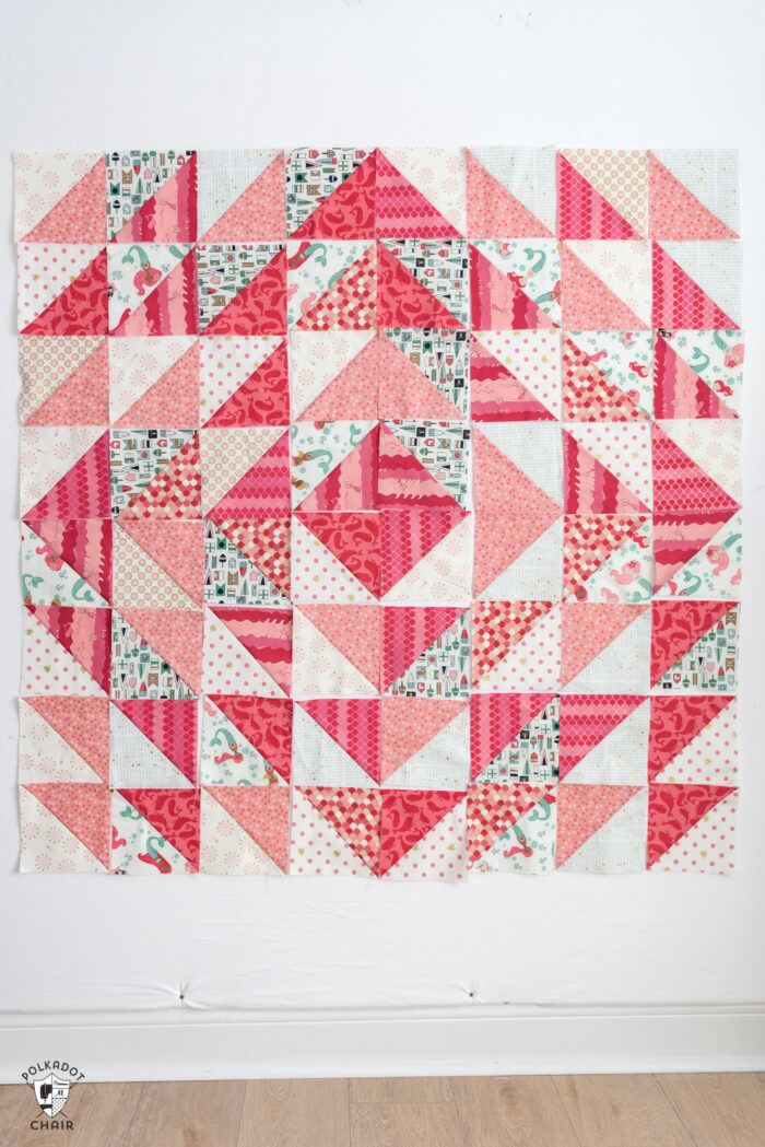 diagram of coral and white half square triangle quilt blocks arranged into 8 rows of 8 squares