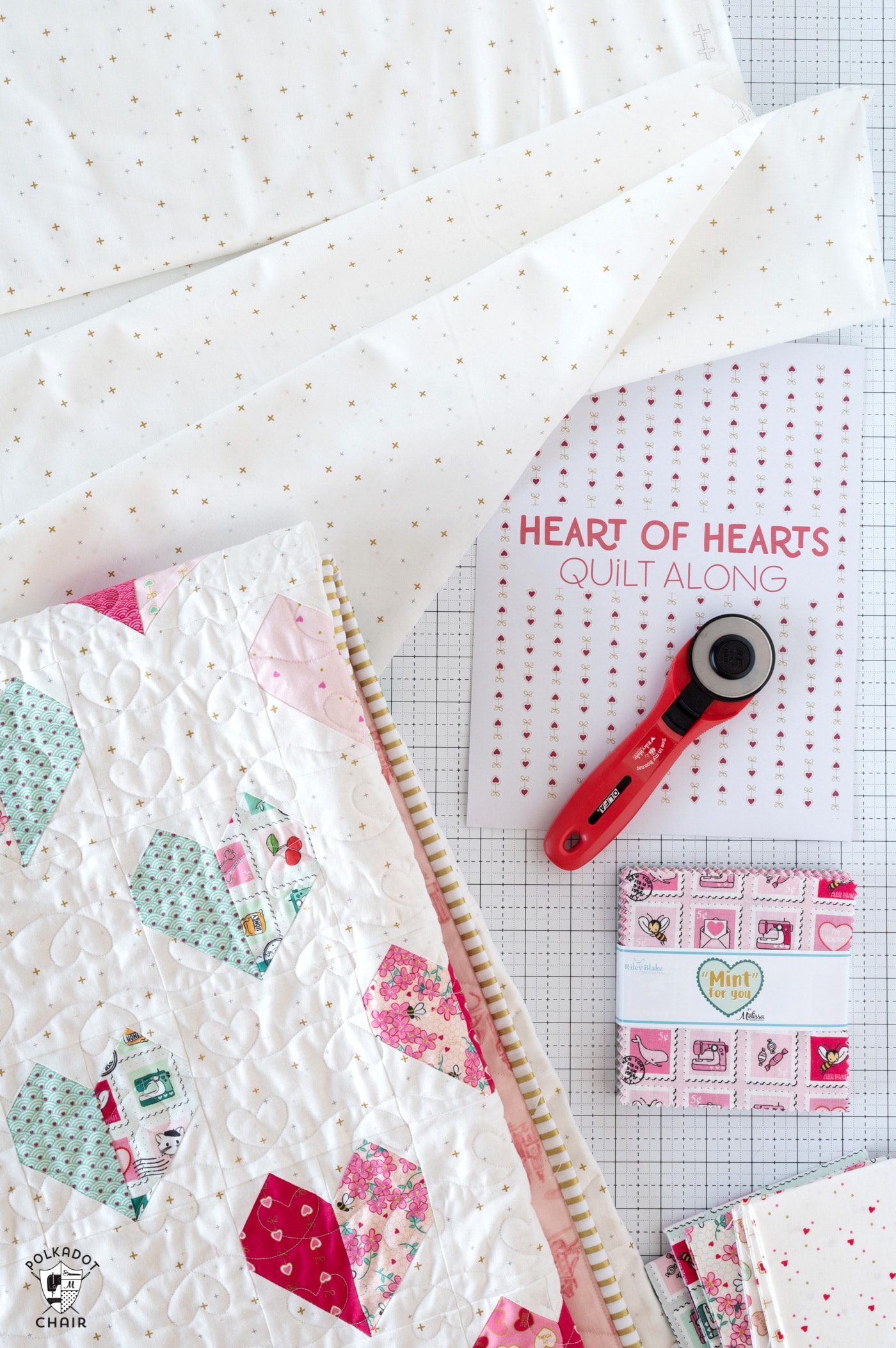 quilt and quilt supplies on white cutting mat