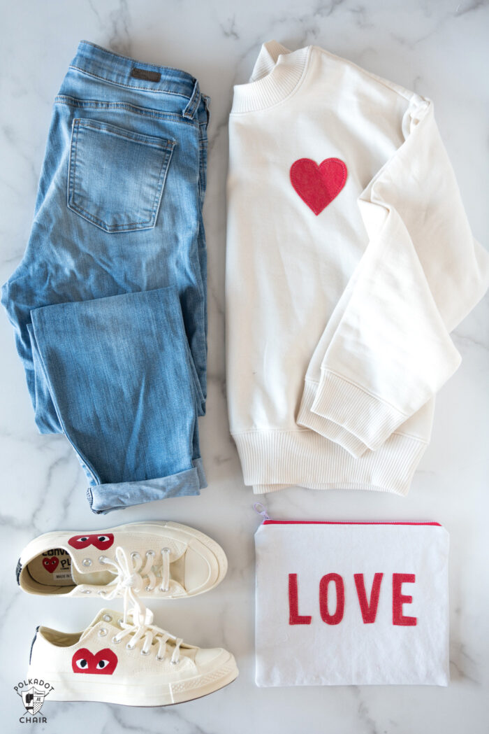 ivory sweatshirt, jeans and shoes on white table