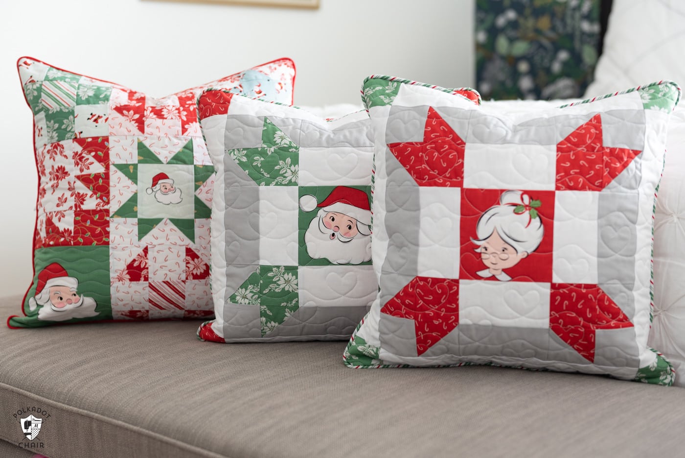 red, green and white patchwork christmas pillows on gray bench