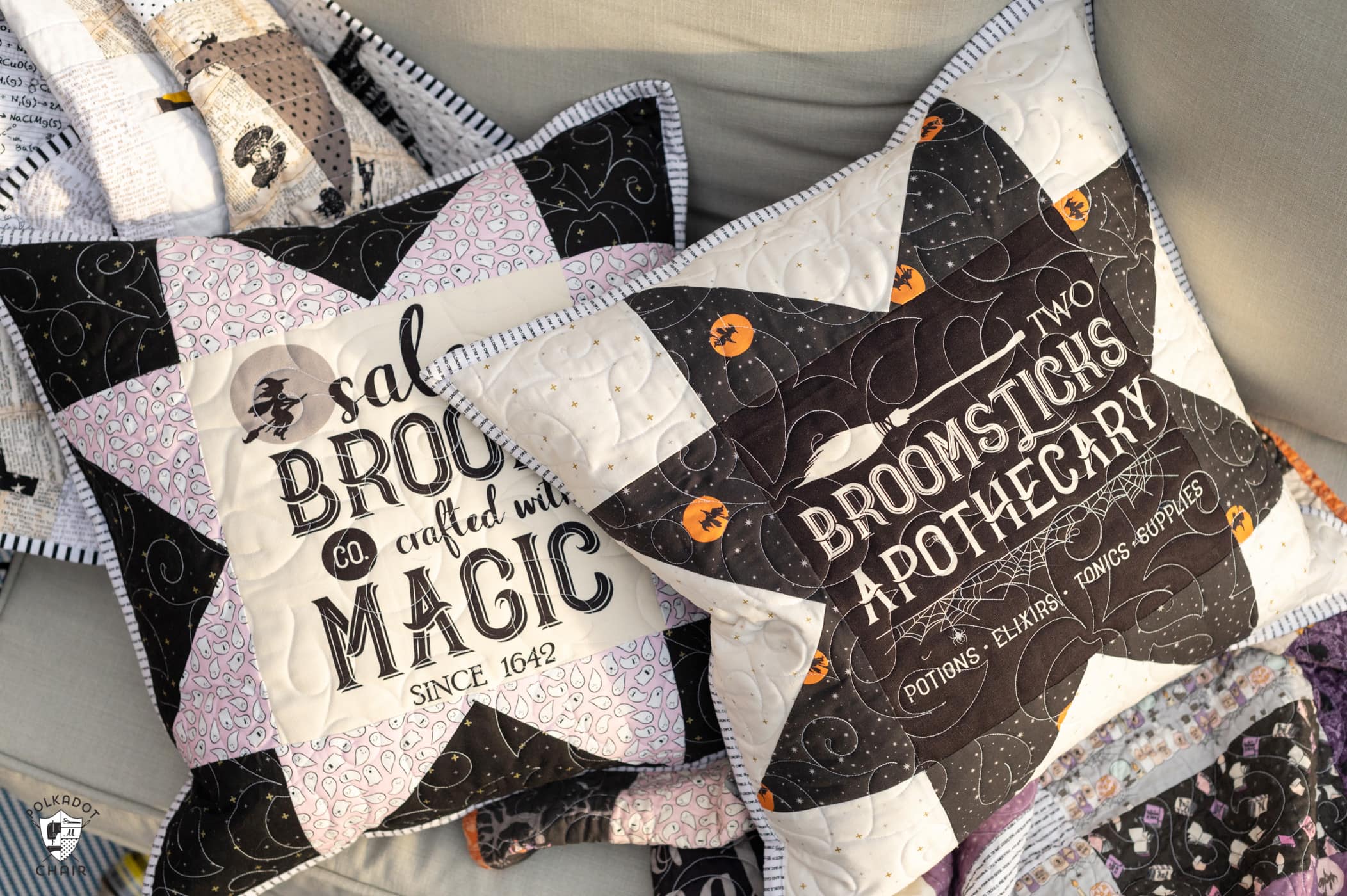 two black and white pillows on deck outdoors with halloween quilt
