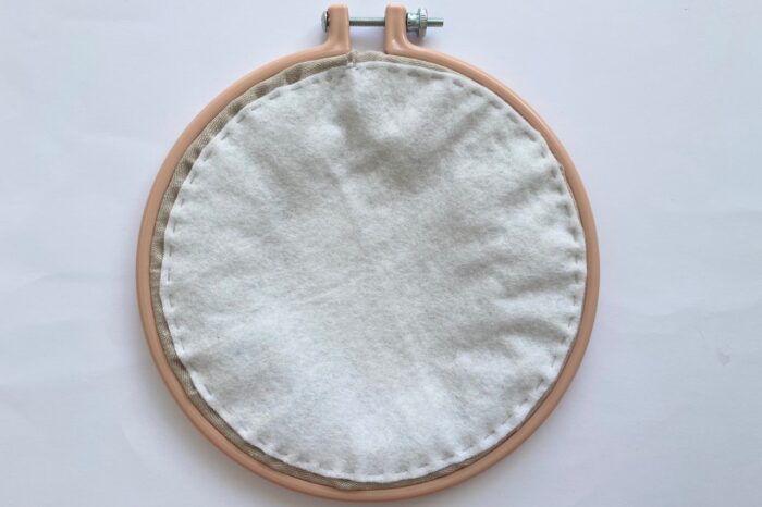 back of embroidery hoop with white felt