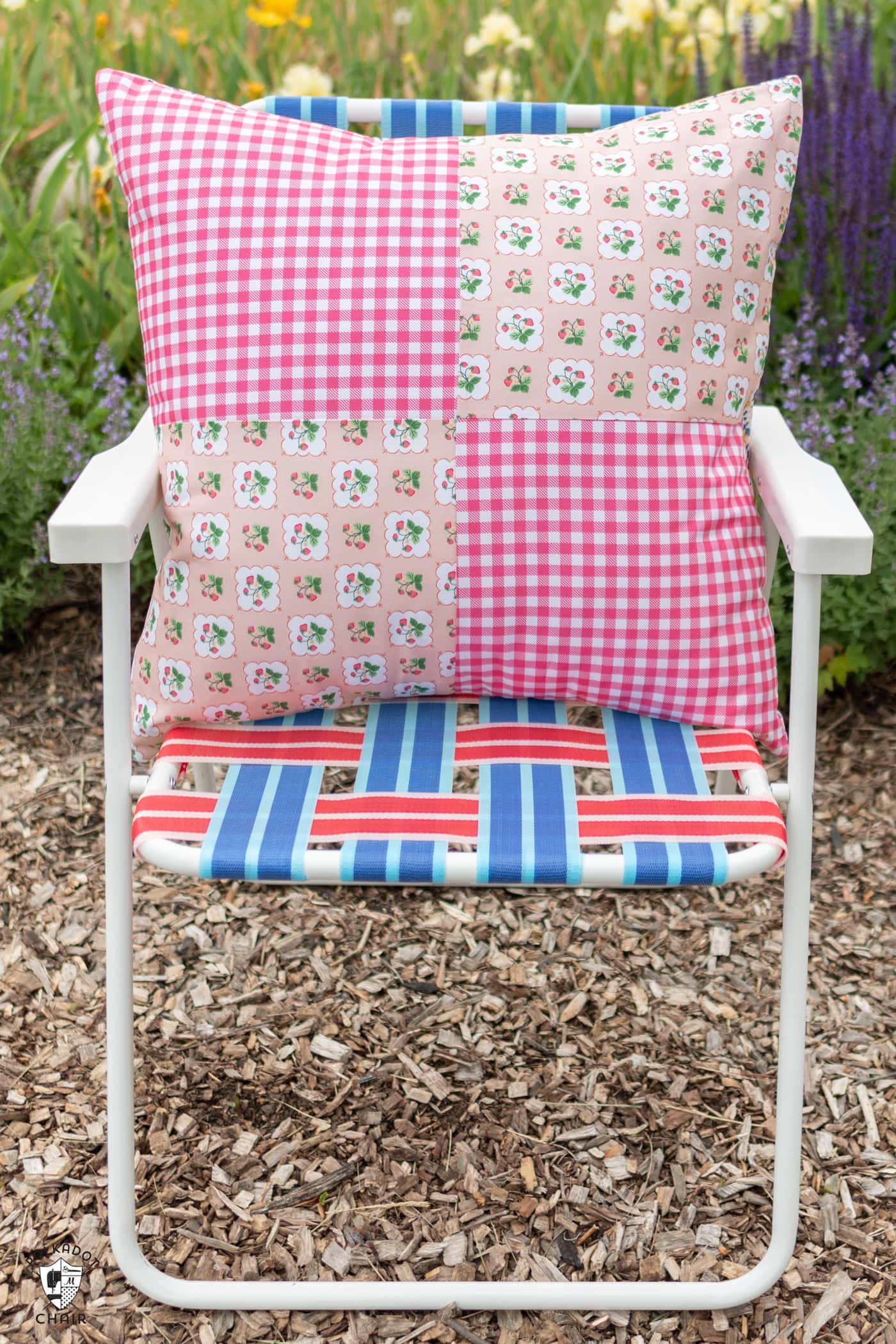large pink pillow on outdoor lawn chair