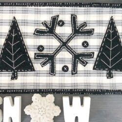 Black and white applique wool mat on gray table